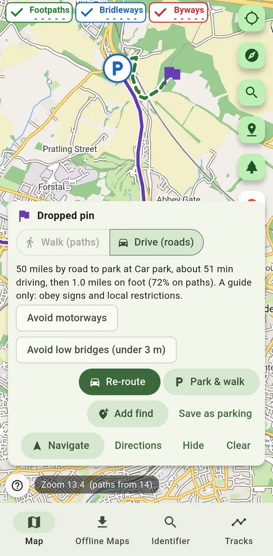 A dropped pin with a driving route to a car park, then a walking route on paths